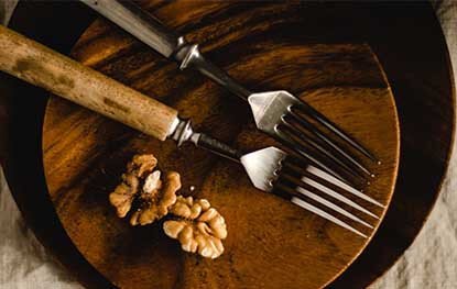 2 forks on wooden plate